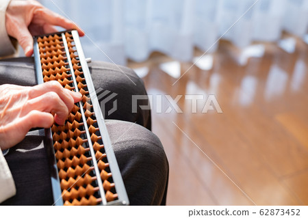 Old man flipping the abacus 62873452