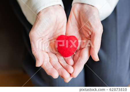 Heart and grandmother's hands 62873810