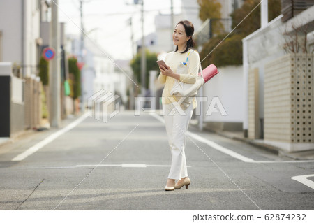 Active senior woman smartphone yoga 62874232