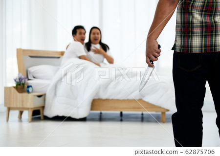 Husband holding knife while wife and adulterer are panic in bed room 62875706