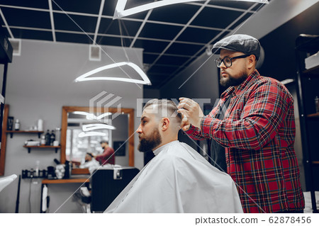 Stylish man sitting in a barbershop Stylish man sitting in a barbershop 62878456
