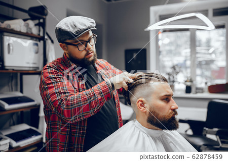 Stylish man sitting in a barbershop Stylish man sitting in a barbershop 62878459