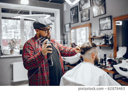 Stylish man sitting in a barbershop Stylish man sitting in a barbershop 62878463