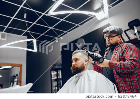 Stylish man sitting in a barbershop Stylish man sitting in a barbershop 62878464