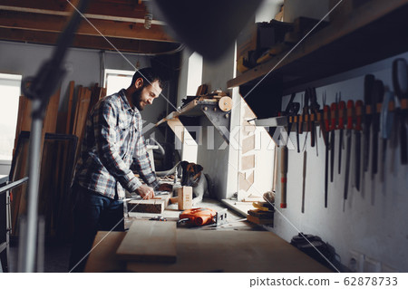 The carpenter works with a tree The carpenter works with a tree 62878733