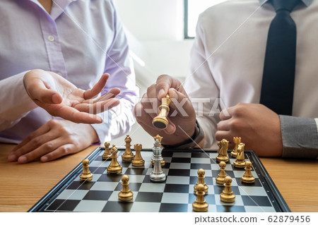 hand of businessman moving chess in competition, shows leadership, followers and business success strategies 62879456