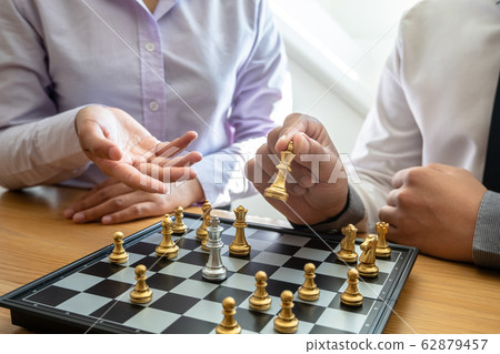 hand of businessman moving chess in competition, shows leadership, followers and business success strategies 62879457