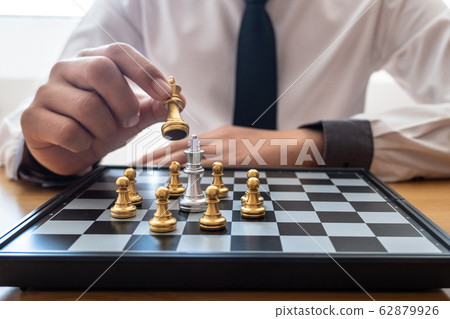 hand of businessman moving chess in competition, shows leadership, followers and business success strategies 62879926