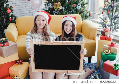 Two young Asian women in Christmas festival and 62880088