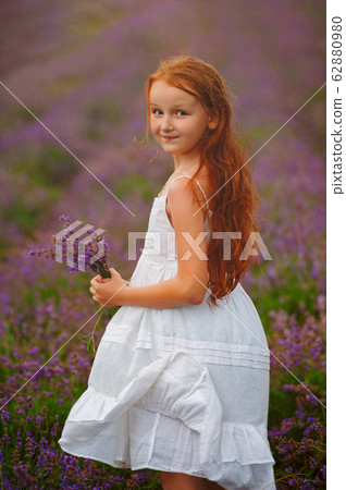 Portrait of a girl with red wet hairin lavender 62880980