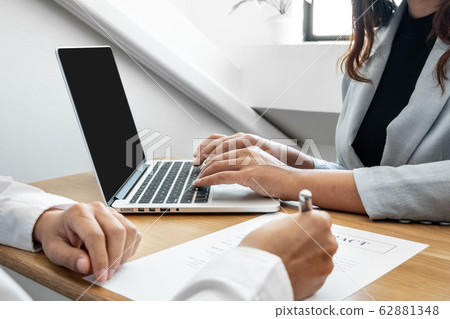 Car dealership provides advice about insurance details and car rental information and delivers the keys after signing the rental contract 62881348