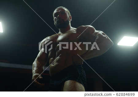 Bodybuilder athletic man workout muscles exercise 62884699