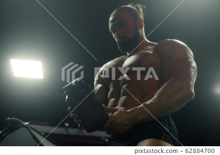 Bodybuilder protein powder after fitness workout 62884700
