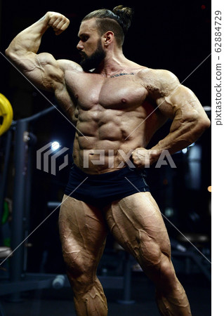 Bodybuilder athletic man workout muscles exercise 62884729