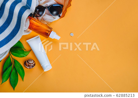 Sunprotection objects, sanscreen. Beach set: hat, sun glasses and protection cream SPF Beach accessories. Summer Travel Vacation Concept 62885213
