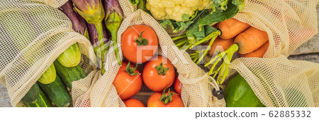 Different vegetables in reusable bags on wooden background. Zero waste concept BANNER, LONG FORMAT 62885332