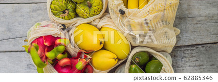 BANNER, LONG FORMAT Fruit in a reusable bag on a stylish wooden kitchen surface. Zero waste concept 62885346