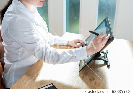 Young woman working with pen tab 62885530