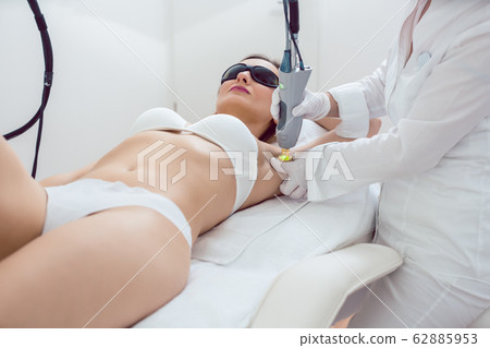 Woman during hair removal using modern laser technology 62885953