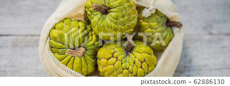Cherimoya in a reusable bag on a stylish wooden kitchen surface. Zero waste concept, plastic free Cherimoya in a reusable bag on a stylish wooden kitchen surface. Zero waste concept, plastic free 62886130