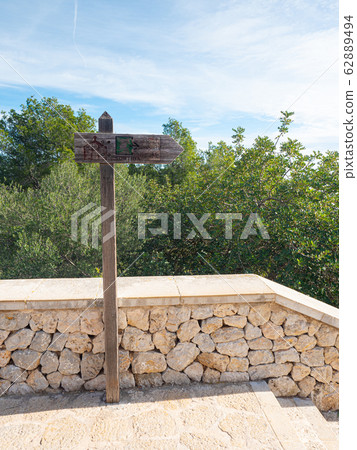 Wooden sign Sortida in front of Castell de Wooden sign Sortida in front of Castell de 62889494