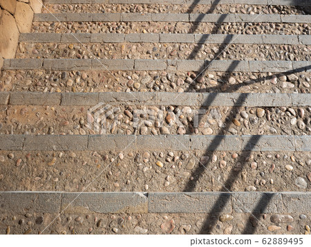 Stairs signate by time. Shadows from handrail. Stairs signate by time. Shadows from handrail. 62889495