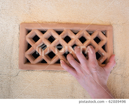Brick wall with a ventilation part. Hand hold ribs Brick wall with a ventilation part. Hand hold ribs 62889496