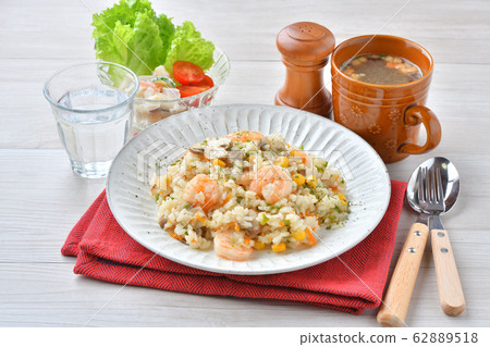 Shrimp pilaf, shrimp and mushroom pilaf, cooked rice with Western-style butter consomme taste. Served with onion soup. 62889518