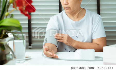 senior woman is detecting blood pressure at home 62889553