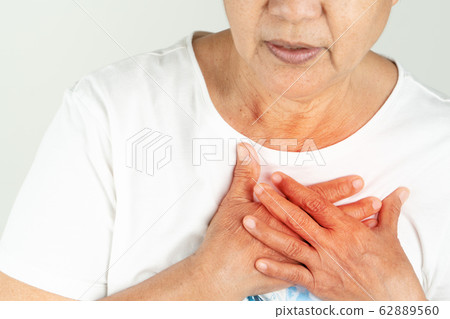 Old woman heart attack holding breast on white background 62889560