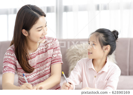 Mom and daughter at home Mom and daughter at home 62890169