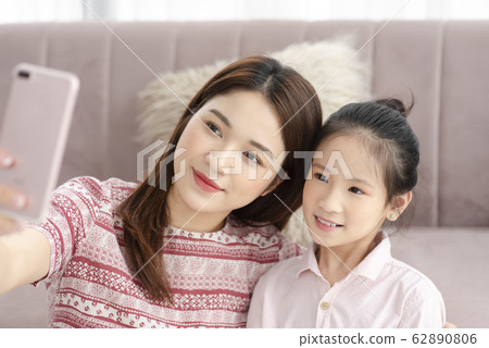 Mom and daughter at home Mom and daughter at home 62890806