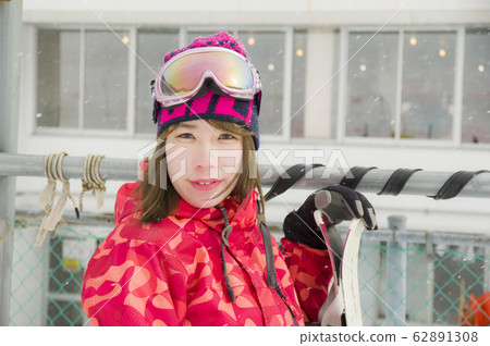 Woman standing in front of ski rest house Woman standing in front of ski rest house 62891308