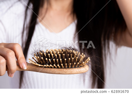 Healthy concept. Woman show her brush with damaged hair 62891670