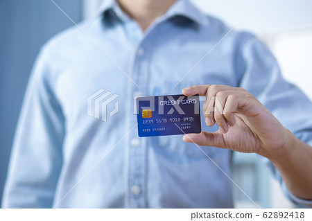 Man hand holding front credit card wear shirt 62892418