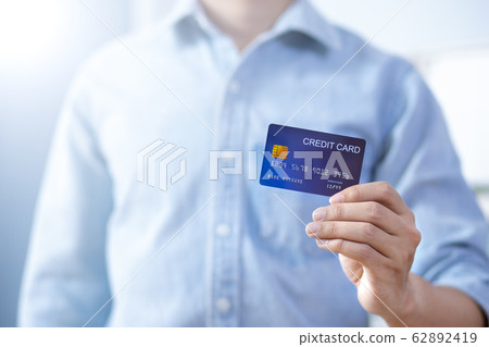 Man hand holding front credit card wear shirt 62892419