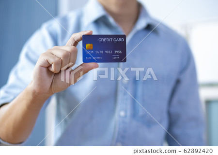 Man hand holding front credit card wear shirt Man hand holding front credit card wear shirt 62892420