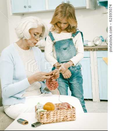 Grandma And Her Grandchild Knitting Fun Together 62893074