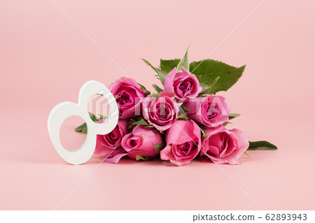Pink Rose flower and 8th Number on pink background Pink Rose flower and 8th Number on pink background 62893943