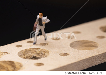 Businessman running while avoiding many pitfalls Businessman running while avoiding many pitfalls 62894199