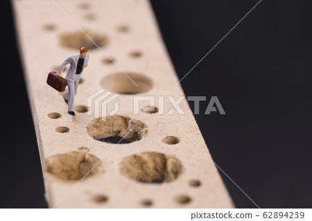 Businessman running while avoiding many pitfalls 62894239