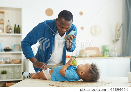 African-American Man Changing Diaper 62894624