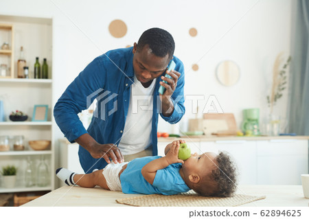 Man Babysitting Son 62894625