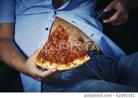 man with a beer belly eating pizza man with a beer belly eating pizza 62895381