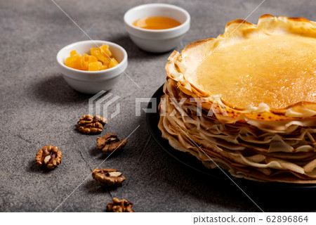 Homemade pancakes with honey oh the grey table. Macro. Homemade pancakes with honey oh the grey table. Macro. 62896864
