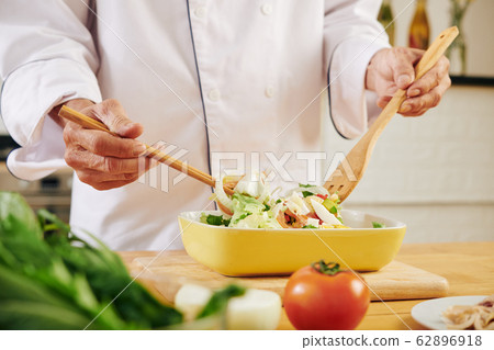 Cook mixing salad Cook mixing salad 62896918