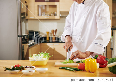 Man cutting ingredients Man cutting ingredients 62896951