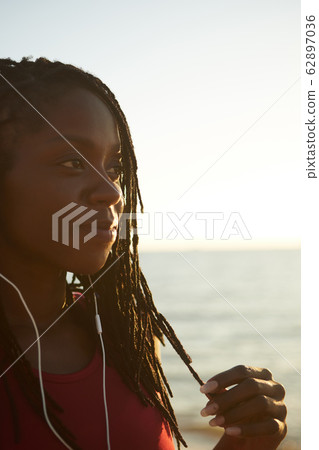 Pensive woman touching her hair Pensive woman touching her hair 62897036