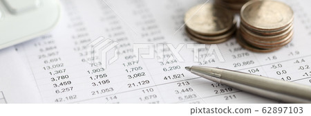 Silver pen lying over financial statistics paper with set of numbers Silver pen lying over financial statistics paper with set of numbers 62897103