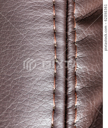 Stitch thread on brown leather material as Stitch thread on brown leather material as 62898361